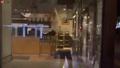Portland rioters smashing windows at starbucks