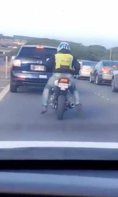 Not all bikers are assholes, some are just Happy like this guy stuck in traffic