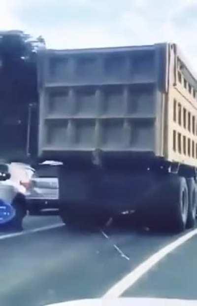 Changing lanes on your scooter in peak-hour, right in front of a truck