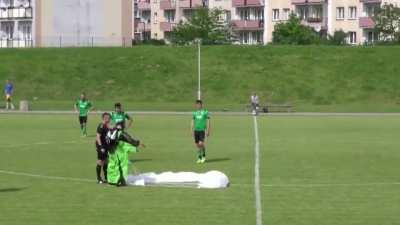Meanwhile in Poland (Parachutist makes an unexpected landing on a soccer pitch during a match in Elblag, Poland)