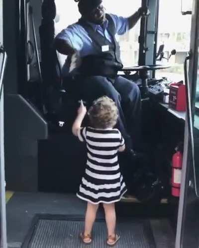 Bus driver dancing together with a girl's favorite song