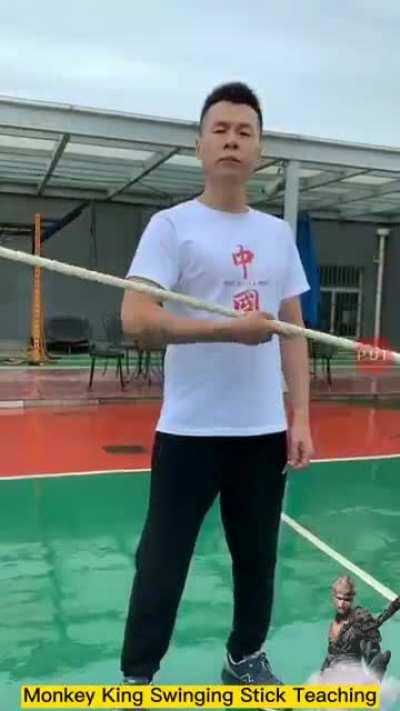Wushu teacher demonstrates the speed of the monkey king swing stick or Ruyi Jingu Bang.