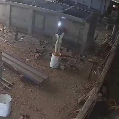 to weld while standing on an oil barrel.