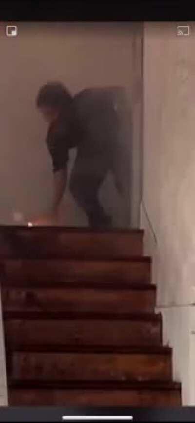 Guy catches fire torching building