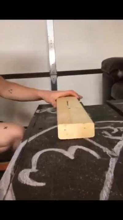 Using a liquor bottle to hammer in nails