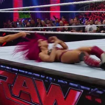 Charlotte Flair giving Sasha Banks a wedgie