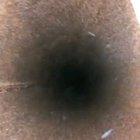 Dropping a small glass jar down a pipe. (Sound On)