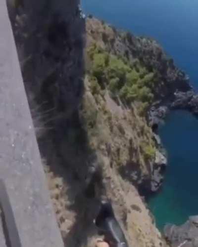 This guy is not living on the edge, he's just cycling on it...