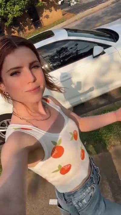 Walking through Nashville with oranges on her top (June 2023)