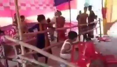 Durga Puja is going on in front of a vandalized Pandel and Durga idol in Bangladesh.