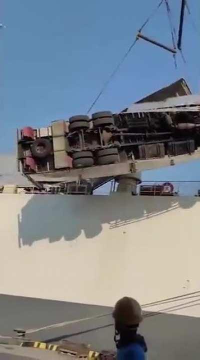 One crane two trucks.