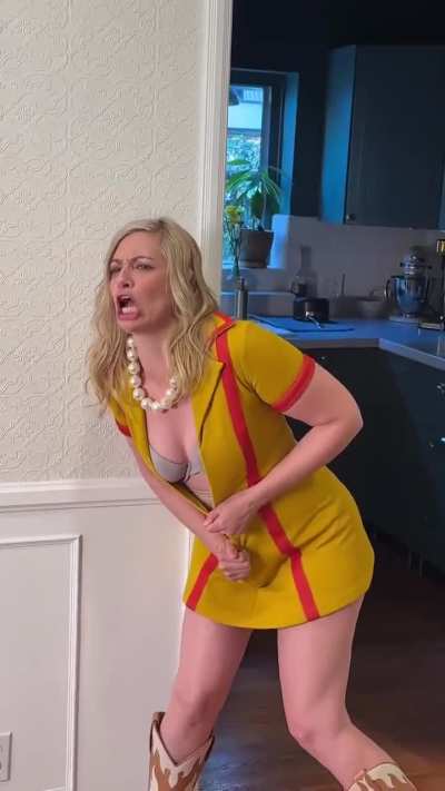 Beth being silly in an Instagram post on 11/25/24. She is joking about perimenopause and the things she is going through. She also tries to put on her waitress outfit from 2 Broke Girls. It is a humorous look at her current life experience.