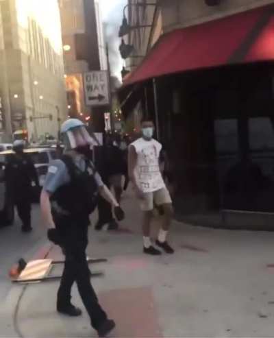 Officer calls protestor a faggot after the protester throws what looks like a cone at him