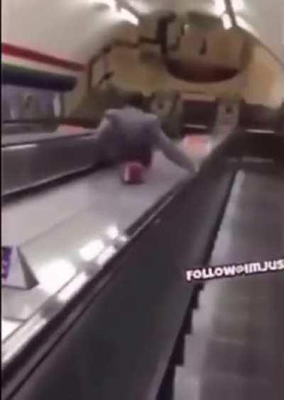 Drunk guy takes an escalator shortcut