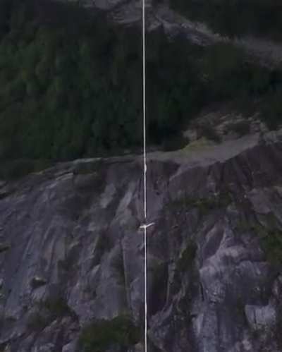 Man almost falls of tightrope, but catches himself