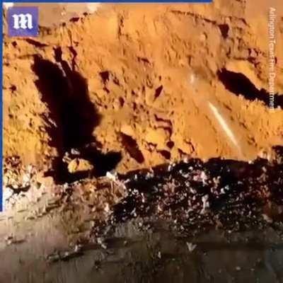 Rescuers dig up road to save dog trapped in drainage pipe