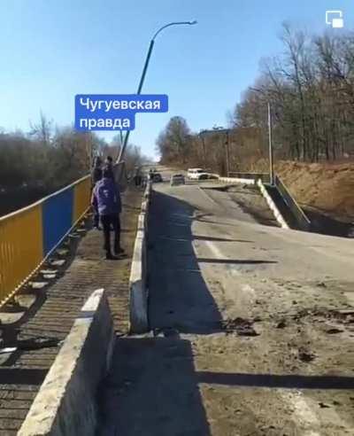Some madman in a car at speed crosses a destroyed bridge in Ukraine