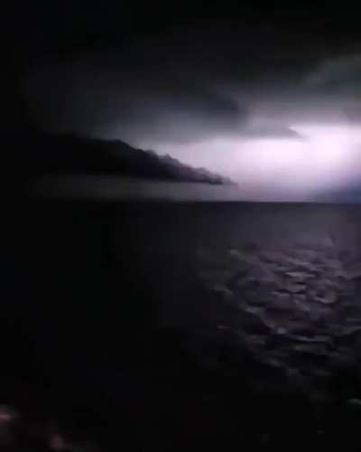 🚂 Thunder lights up the sky, revealing the shape of something immense.