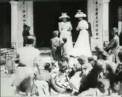 2 French Women throwing grains and coins to starving children in Vietnam, 1915.