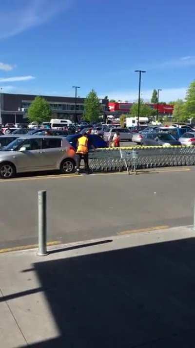 Pushing a massive train of shopping karts, all at once
