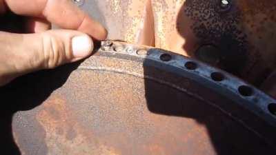 Man dropping screw into turbine engine