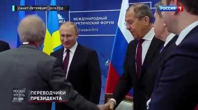 Putin attempting to shake people's hands