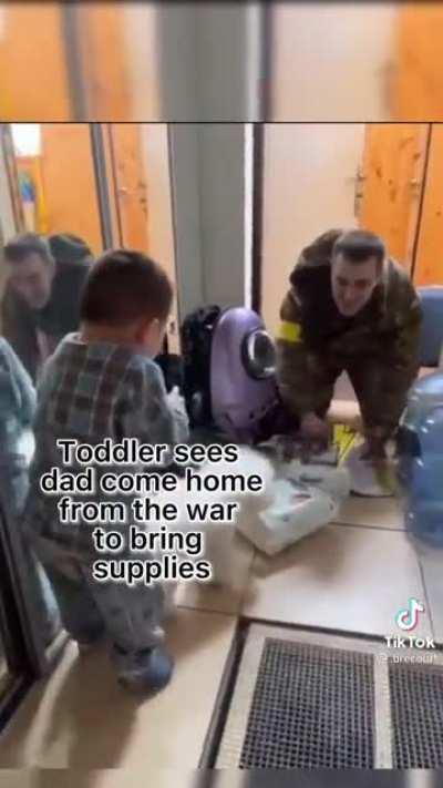 Toddler in Ukraine greets his soldier father as he brings the family supplies