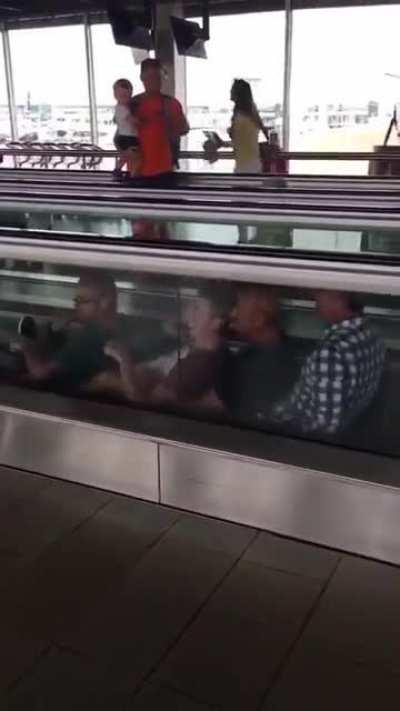 Four men having a little fun at an airport