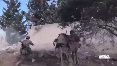 Syrian opposition fighters busting through a wall with a truck, breaching a regime position southwest of Saraqib.