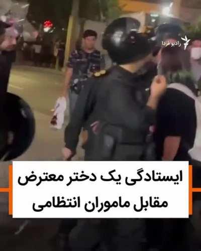Iranian woman standing up to group of cops