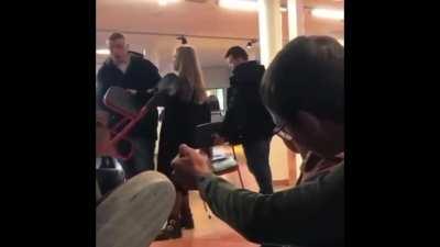 First clip is a girl(16) stealing someone’s(13) chair . 2nd clip is a man 16y old knocking her out.