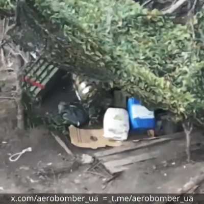 russian drone operators, operating out of a dugout stacked with fuel tanks, are taken out by a single drone dropped munition. Aerobomber unit.