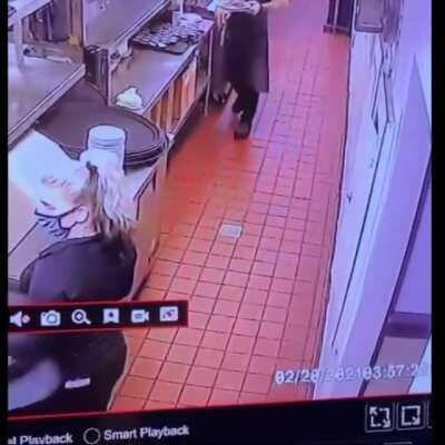 Woman sees that her coworker is about to pass out so she moves to catch him before his head hits the ground
