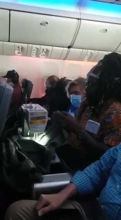 Dude sewing on a plane