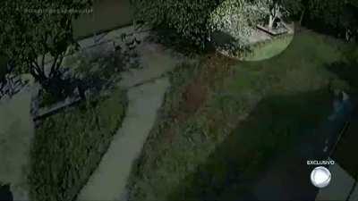 CCTV by Suzano school shooting, inside the school, showing Guilherme Taucci running after students and chaos in the school yard.