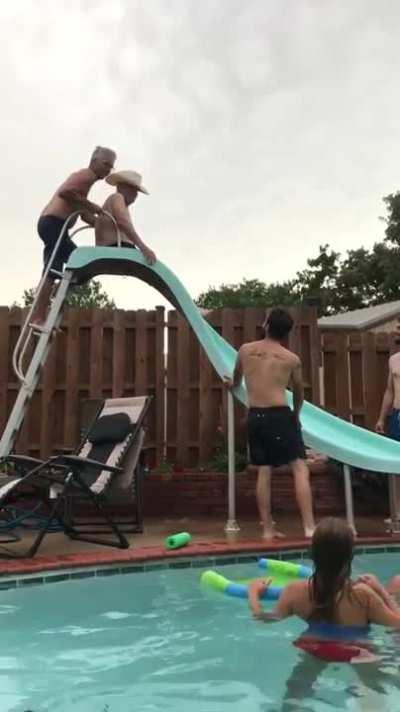 Helping Grandpa down the water slide