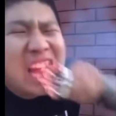 Man burns his mouth eating cigarettes.