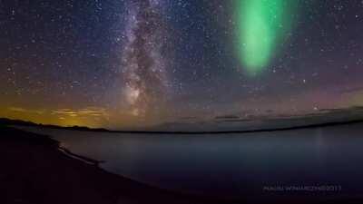 Milky Way timelapse photobombed by the Aurora Borealis over Loch More in Scotland. Credit: Maciej Winiarczyk