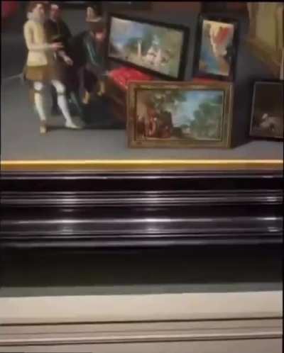 Museum visitor shows incredible detailing (picture within a picture) in a painting from 1600s