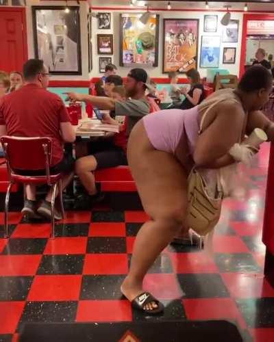 Woman twerkin in front of family at restaurant