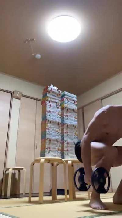 This man jumping over an approx 5ft stack of tissue boxes from a seated position