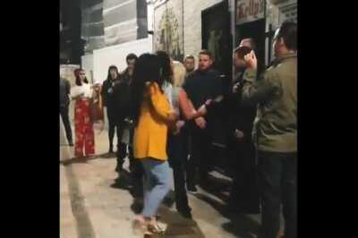 Three ladies try to fight a bouncer