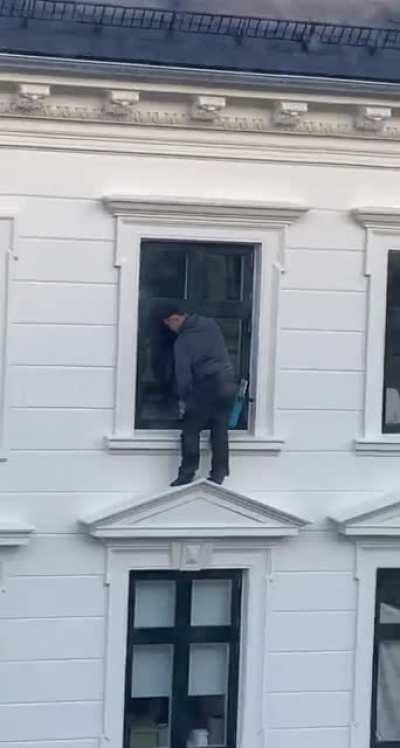 Washing windows on the 5th floor