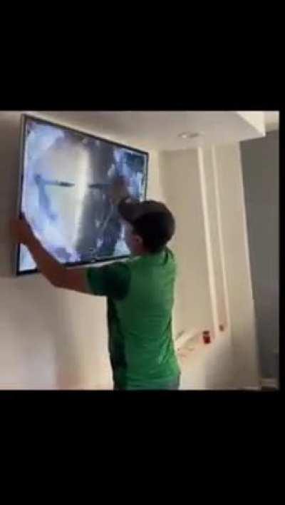 Soccar fan gets upset and starts to punch the tv because his team lost at the World Cup in Qatar