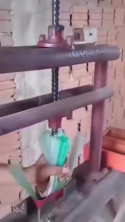 Repurposing a plastic bottle into broom bristles.