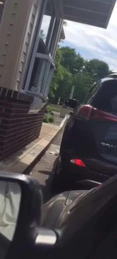 Woman upset at Dunkin’ Donuts gets a face full of iced coffee and banshee screams.