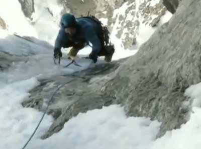 Climber clips in right before the ice sheet he's on breaks
