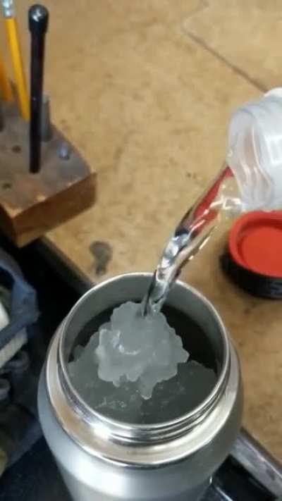 Pouring a cool thermos of ice