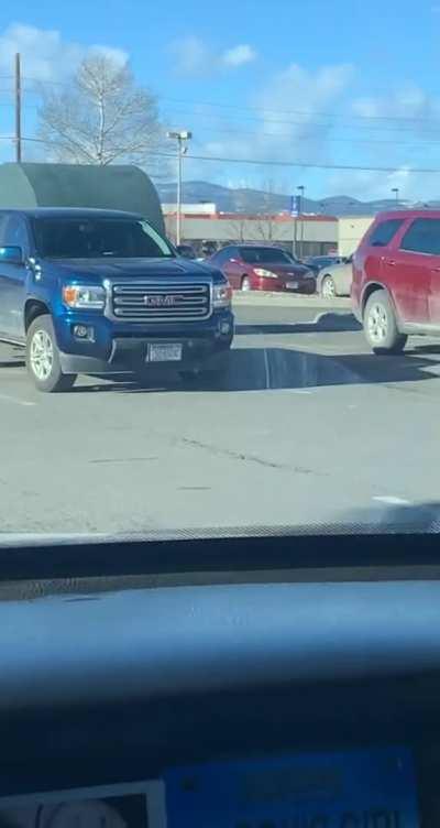 Cylinder rolls perfectly between two cars in a parking lot
