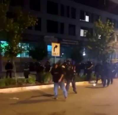 Police brutality - lone protestor gets a flash-bang to his face after getting pepper sprayed.